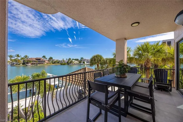 a view of a balcony with furniture and a potted plant