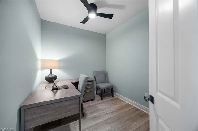 a room with a table chair and wooden floor