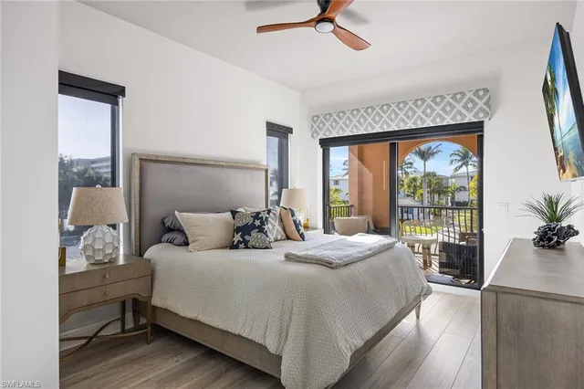 a bedroom with a large bed and a large window