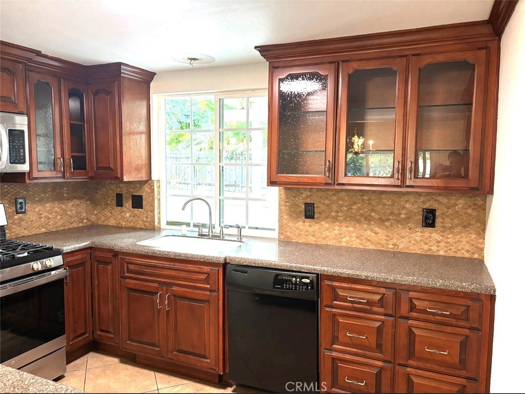 1164 Massachusetts Avenue Riverside, CA 92507 - Photo 6 of 14 a kitchen with granite countertop stainless steel appliances a sink window and cabinets