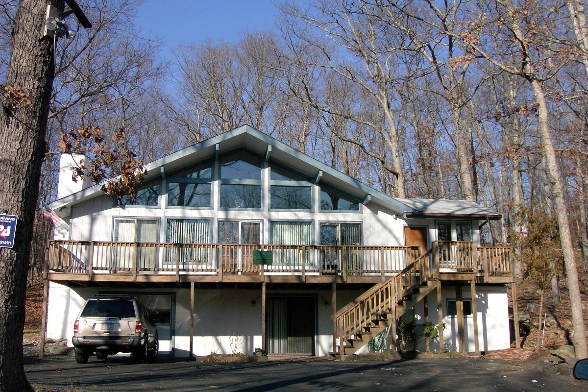 Saunders Drive Bushkill, PA 18324 - Photo 1 of 10 a front view of a house with large trees