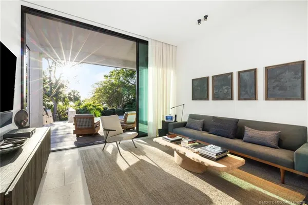 a view of a hallway with a livingroom with furniture