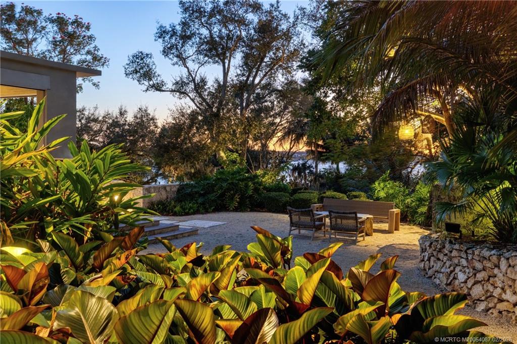 109 South River Road Stuart, FL 34996 - Photo 29 of 98 a patio with table and chairs and potted plants