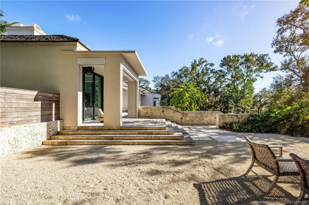 109 South River Road Stuart, FL 34996 - Photo 30 of 98 a view of a patio with table and chairs and potted plants
