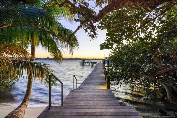 an aerial view of a house with a yard basket ball court and outdoor seating