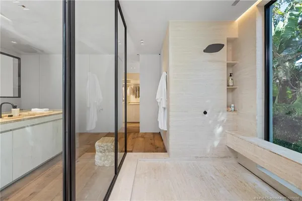 a bedroom with a bed and large window