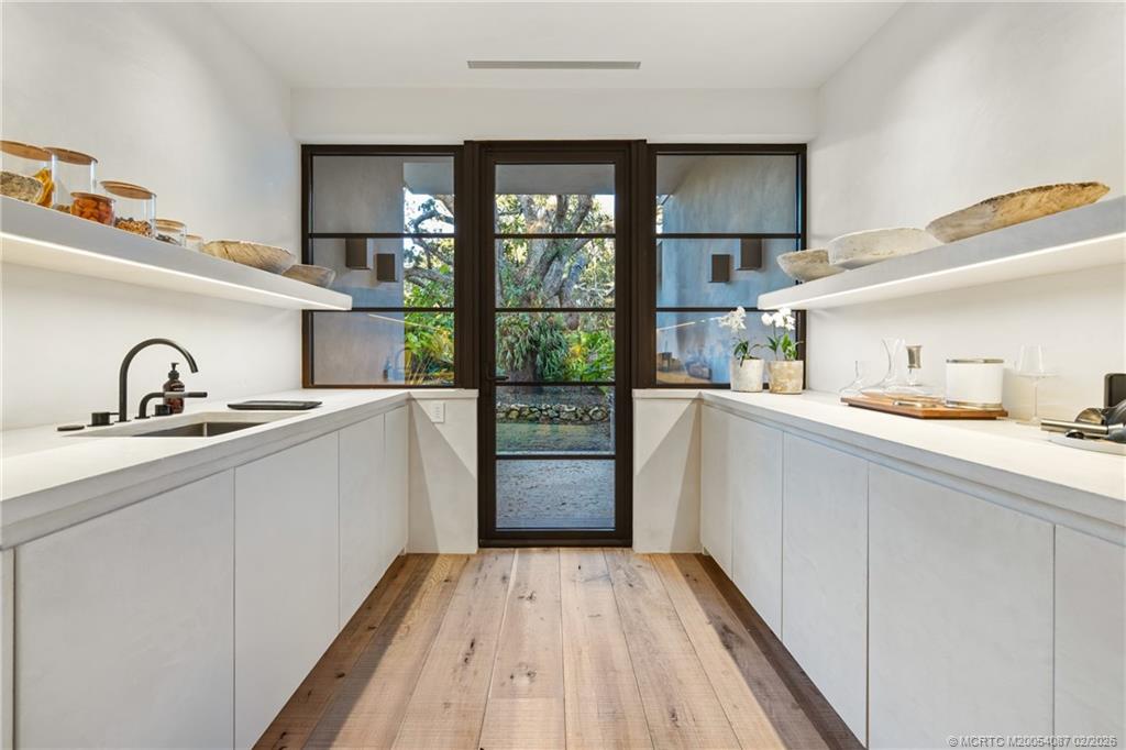 109 South River Road Stuart, FL 34996 - Photo 49 of 98 a kitchen with a sink and wooden floor