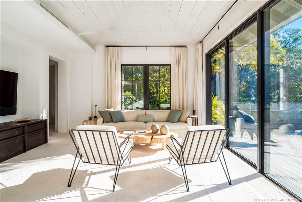 109 South River Road Stuart, FL 34996 - Photo 52 of 98 a living room with a large window and a table