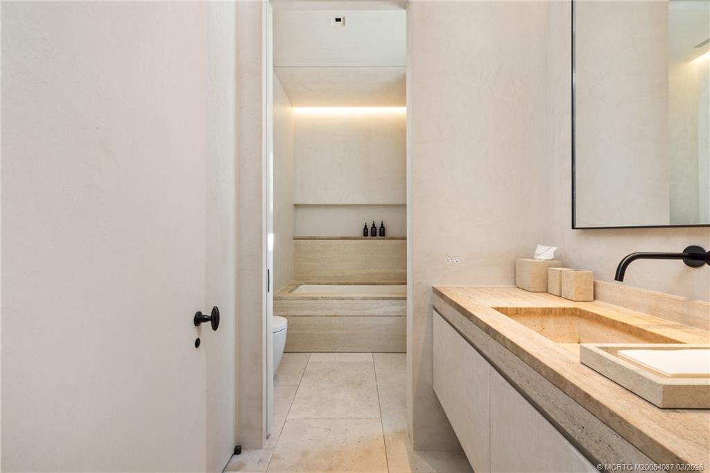 109 South River Road Stuart, FL 34996 - Photo 54 of 98 a bathroom with a granite countertop sink and a mirror