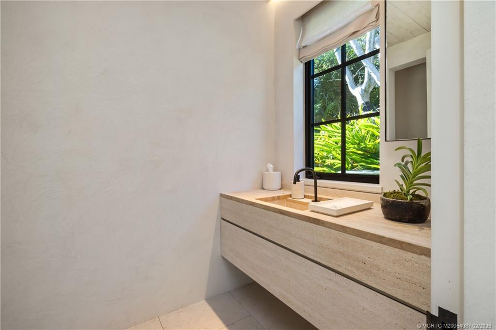 109 South River Road Stuart, FL 34996 - Photo 56 of 98 a bathroom with a granite countertop sink and a window