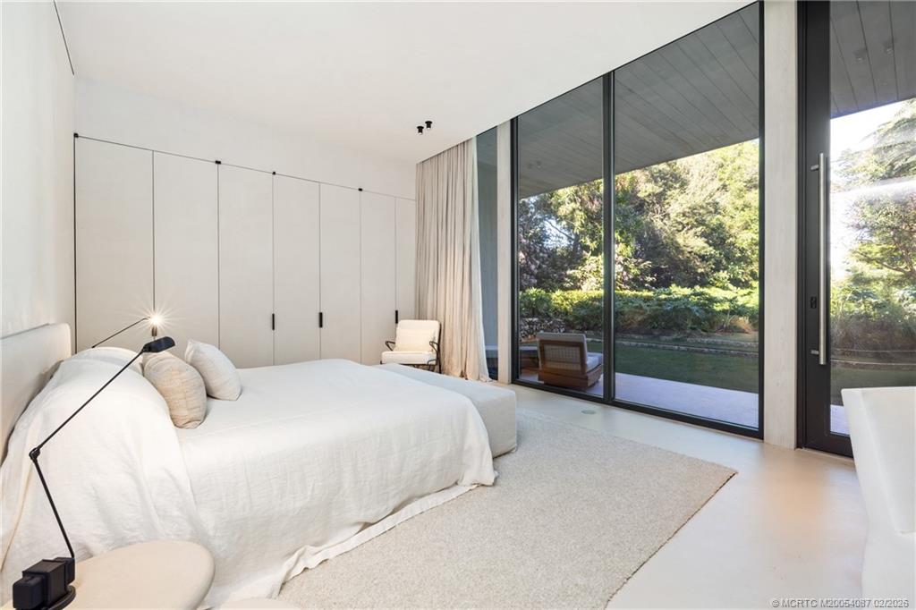 109 South River Road Stuart, FL 34996 - Photo 72 of 98 a bedroom with a bed and large window