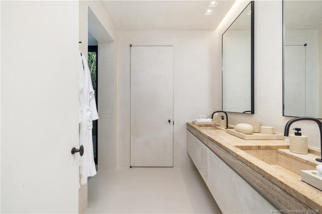 109 South River Road Stuart, FL 34996 - Photo 73 of 98 a bathroom with a double vanity sink and mirror