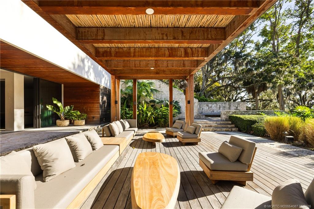109 South River Road Stuart, FL 34996 - Photo 87 of 98 a view of a patio with couches chairs and a potted plant