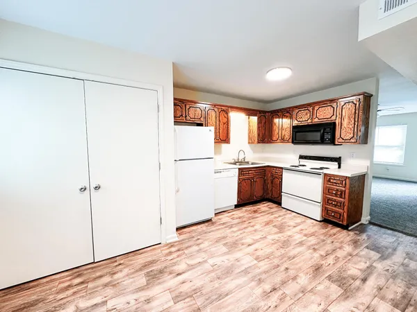 a kitchen with stainless steel appliances a refrigerator and a stove top oven