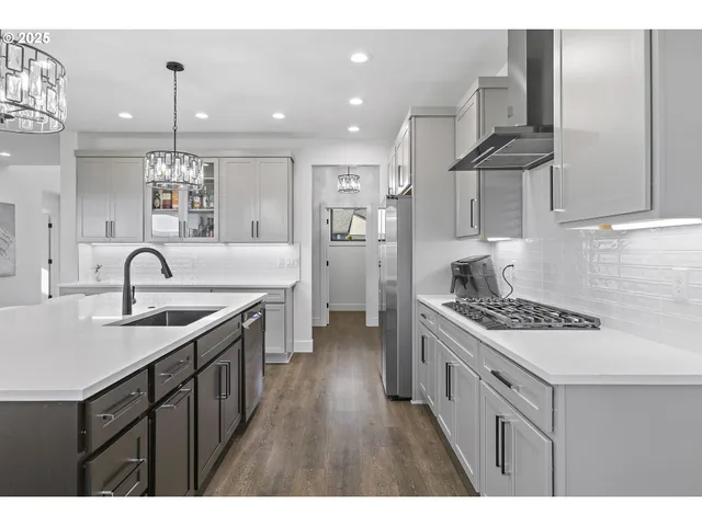 a kitchen with a sink stove and cabinets