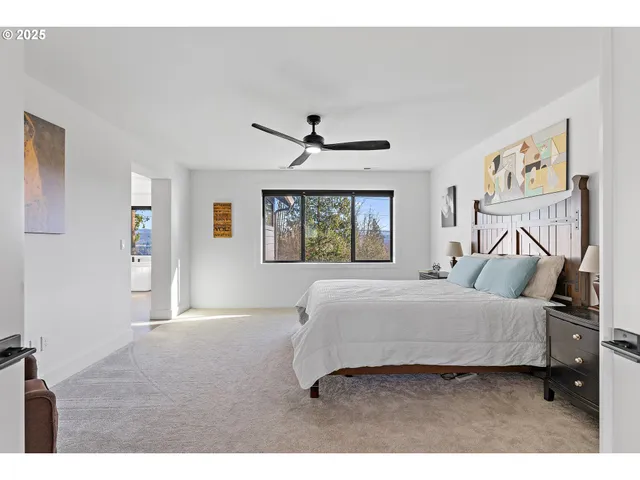 a bedroom with a large bed and a window