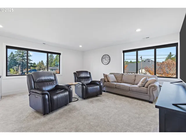 a living room with furniture and large windows