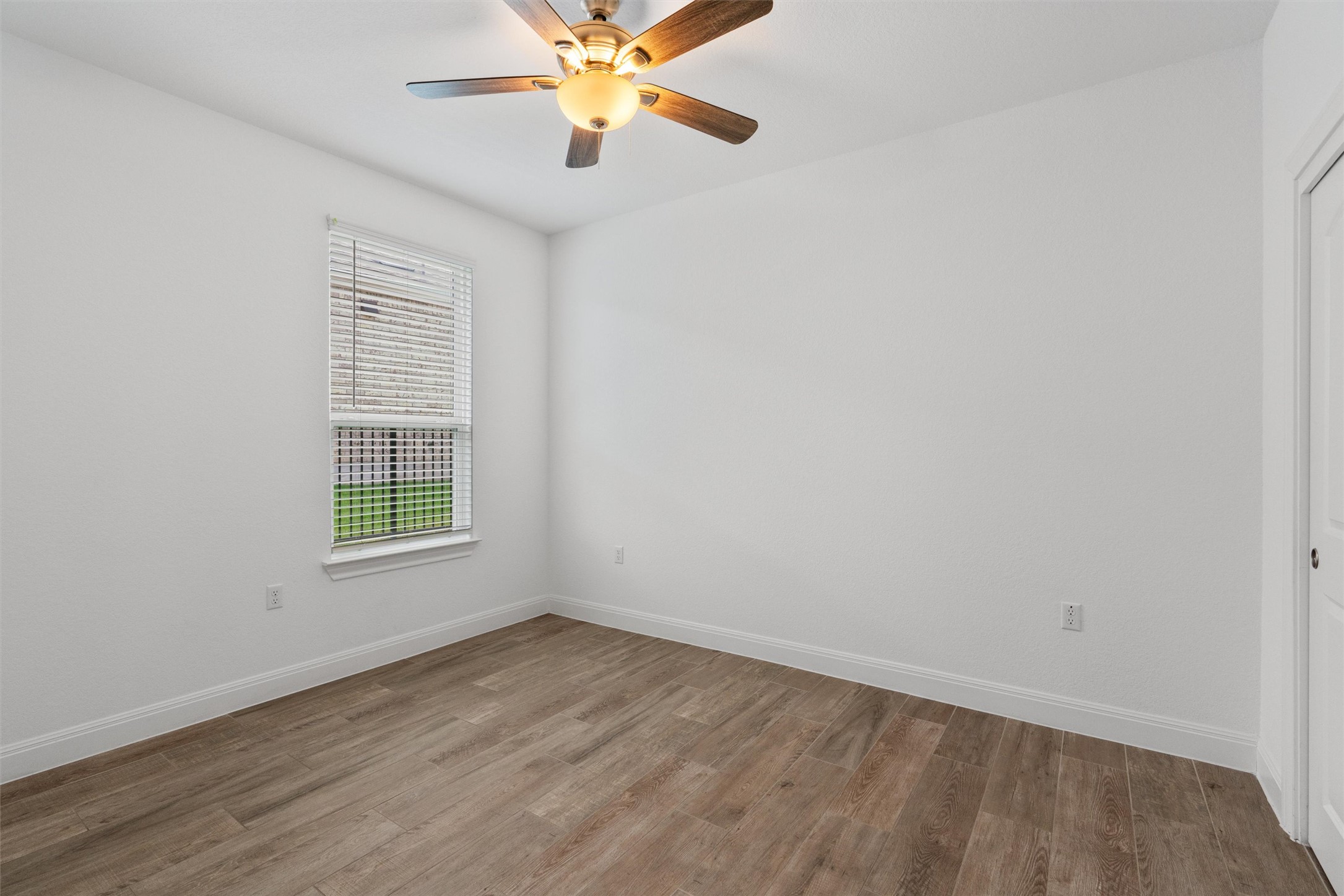 202 Spanish Star Street Georgetown, TX 78633 - Photo 23 of 32 an empty room with windows and fan