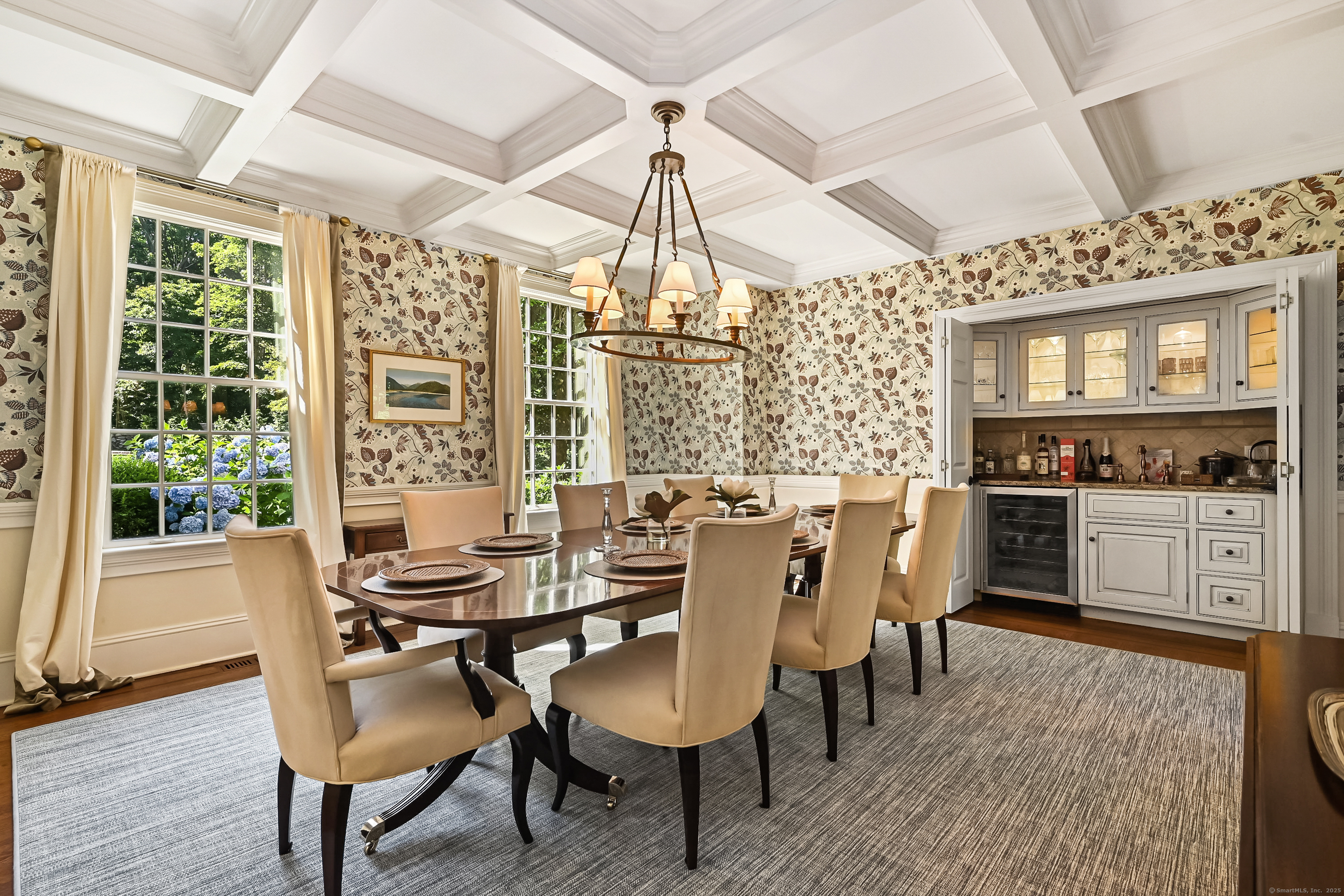 1084 Sturges Highway Fairfield, CT 06880 - Photo 12 of 40 a dining room with furniture a chandelier and wooden floor