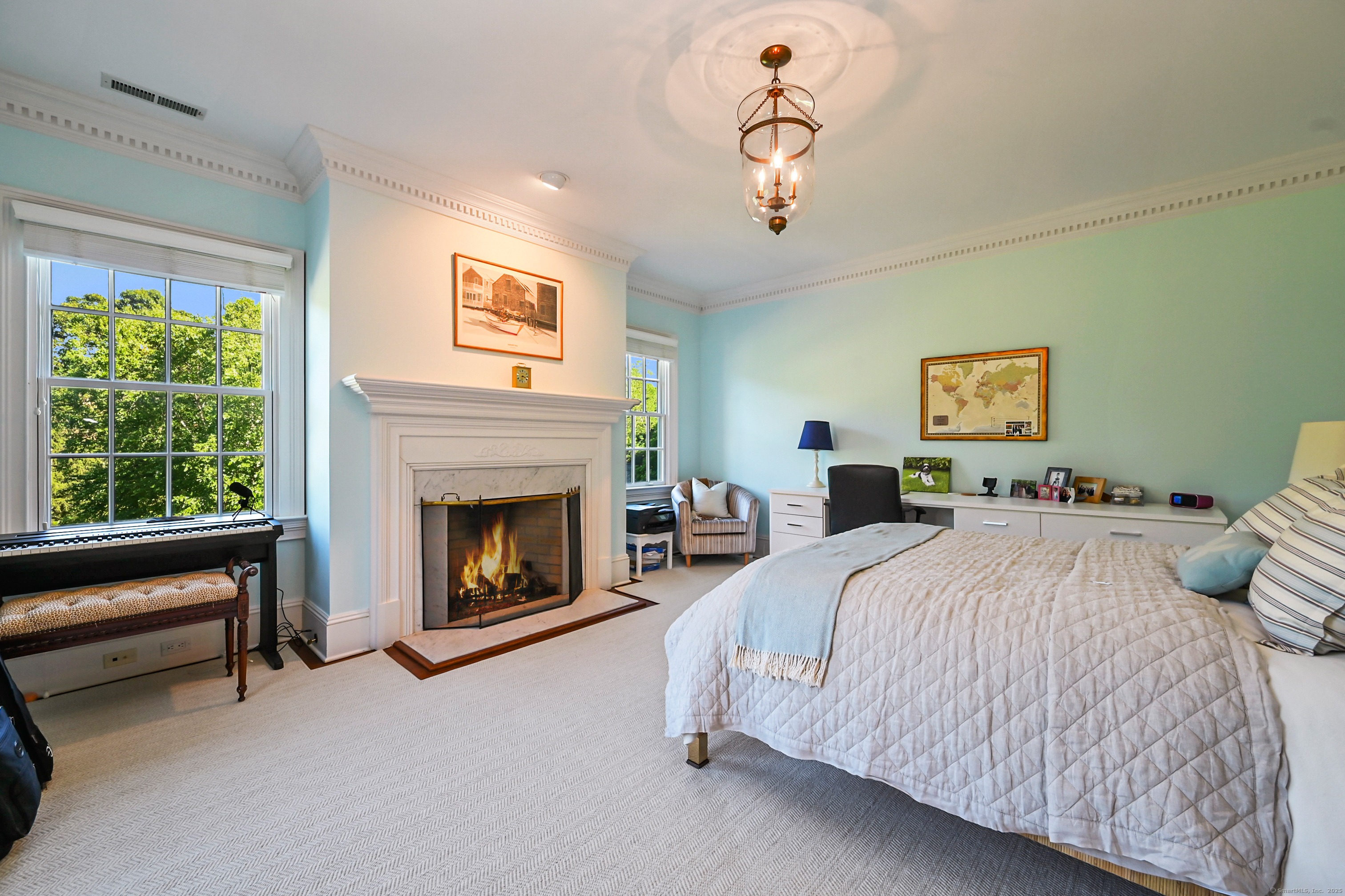 1084 Sturges Highway Fairfield, CT 06880 - Photo 20 of 40 a spacious bedroom with a bed and a fireplace