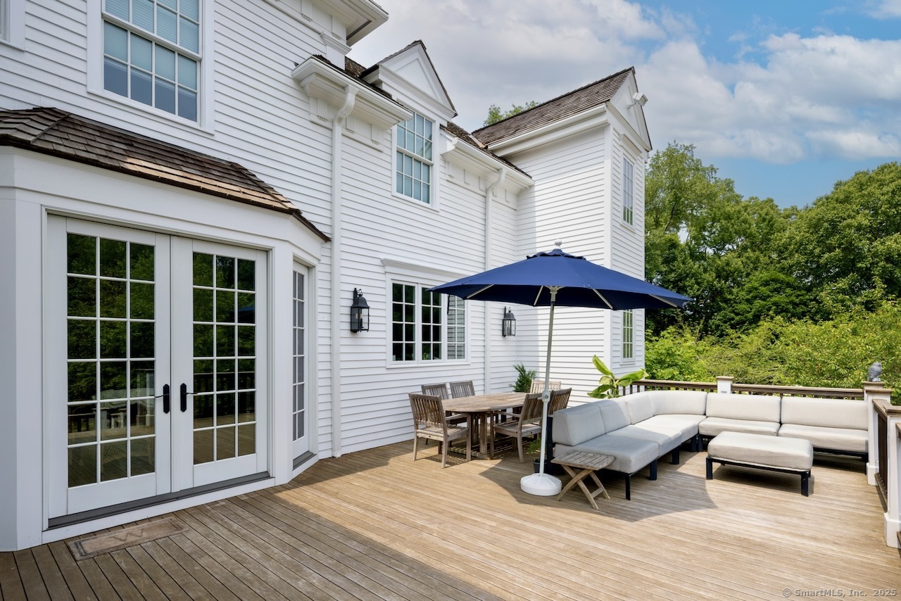 1084 Sturges Highway Fairfield, CT 06880 - Photo 27 of 40 a view of a patio with a table and chairs under an umbrella