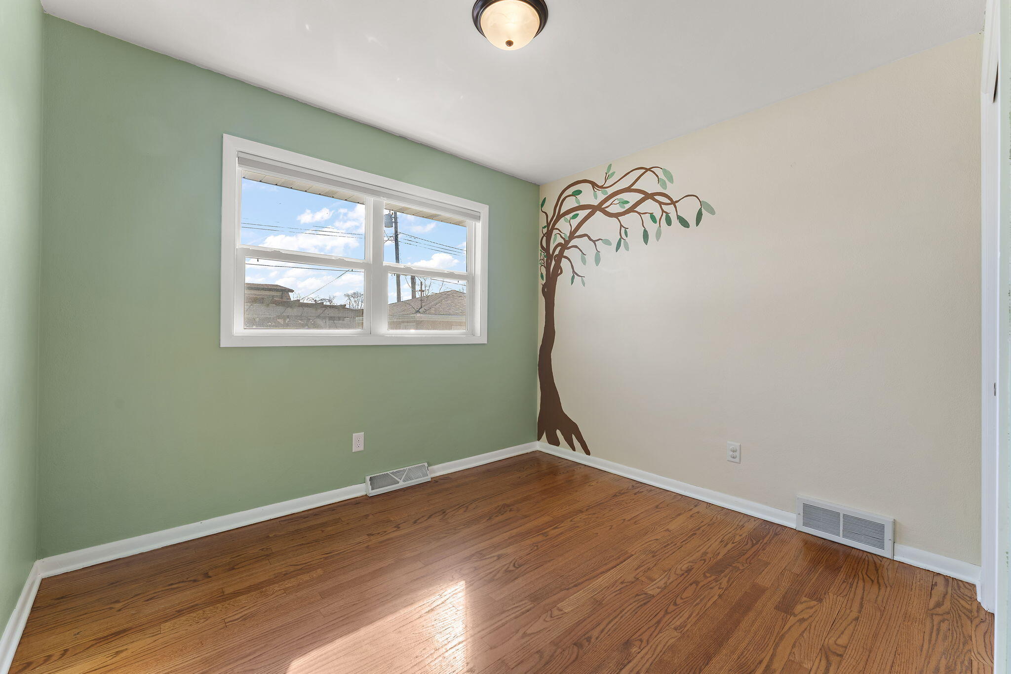 947 North Wood Street Griffith, IN 46319 - Photo 17 of 25 an empty room with wooden floor and windows