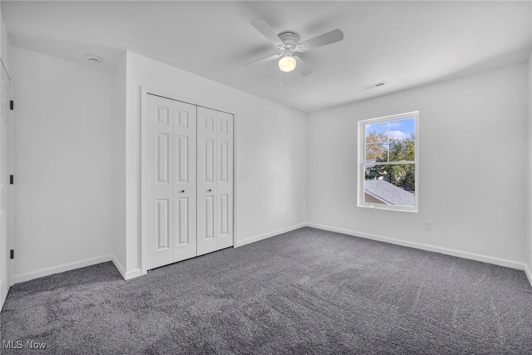 3653 Pennington Road Cleveland, OH 44120 - Photo 28 of 41 Unfurnished bedroom featuring dark carpet, a closet, and ceiling fan