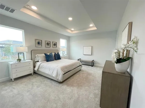 a view of a house with a yard and a tree