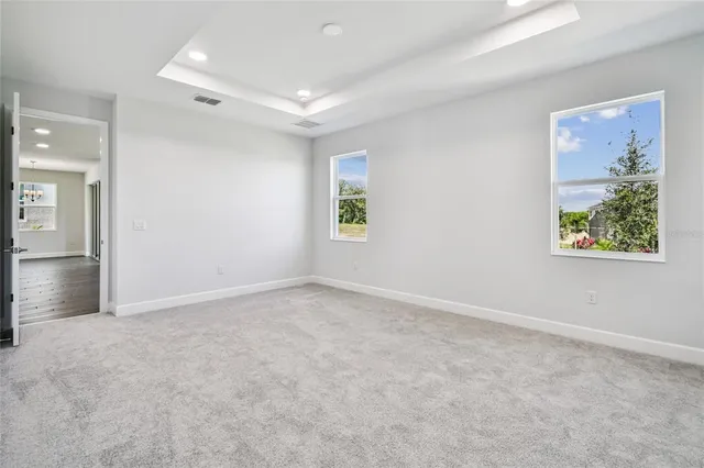 a view of kitchen with stainless steel appliances granite countertop white cabinets and wooden floor