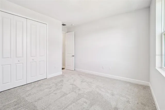 a large kitchen with stainless steel appliances kitchen island a large counter top and wooden floor