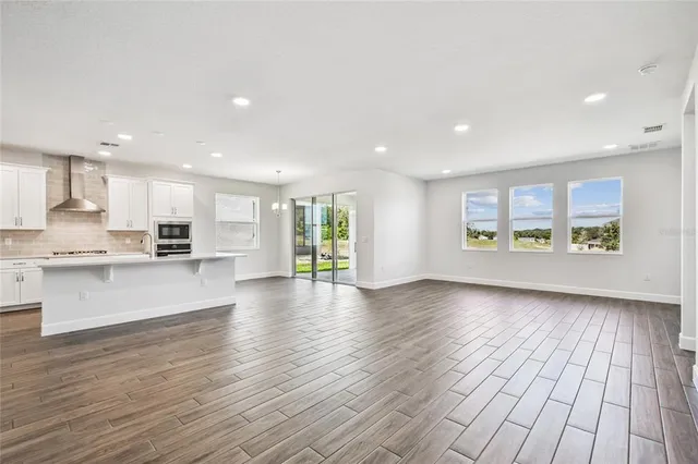 a kitchen with stainless steel appliances sink stove microwave and cabinets