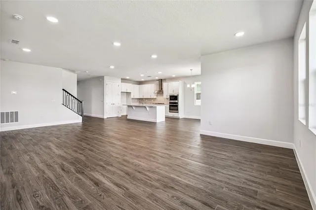 a kitchen with stainless steel appliances kitchen island granite countertop a stove a sink and white cabinets
