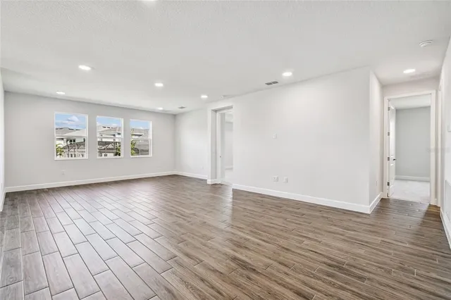 a large white kitchen with kitchen island a sink appliances and cabinets
