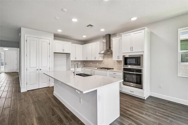 a bathroom with a granite countertop sink toilet tub and shower