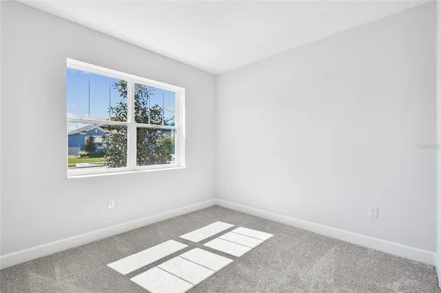 a front view of a house with a garden and plants