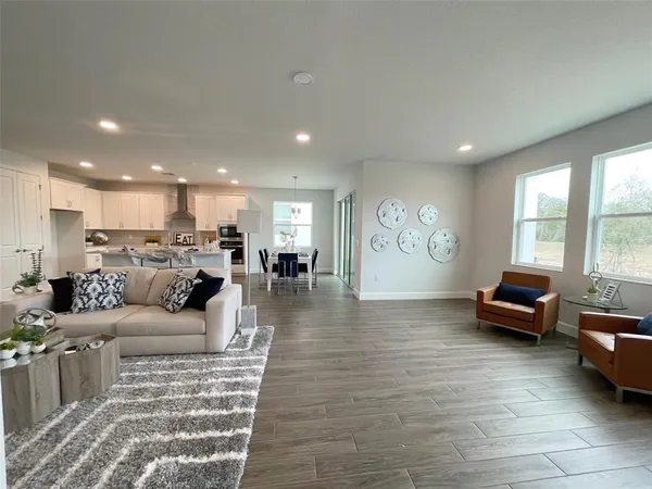 a living room with furniture wooden floor and a flat screen tv