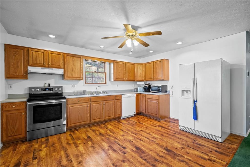 573 Shaffer Road Hookstown, PA 15050 - Photo 11 of 41 a kitchen with stainless steel appliances granite countertop a stove cabinets and refrigerator