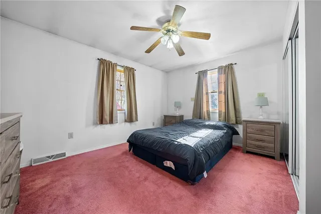 a bedroom with a bed dresser and a window