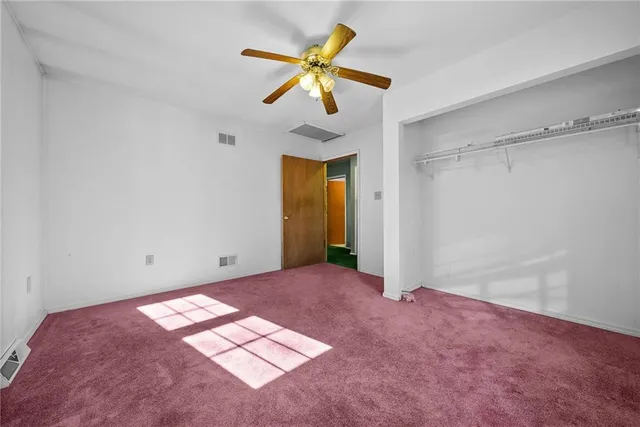 a view of empty room with ceiling fan