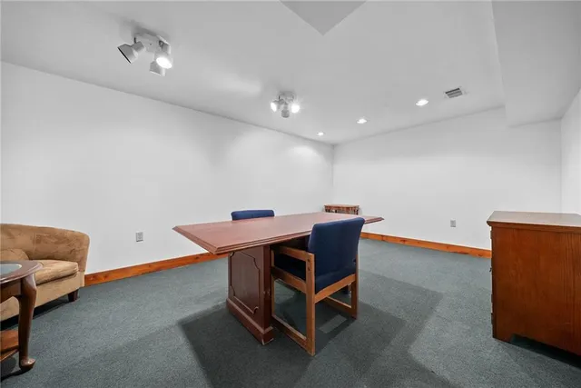 a room with furniture and a air conditioner vent