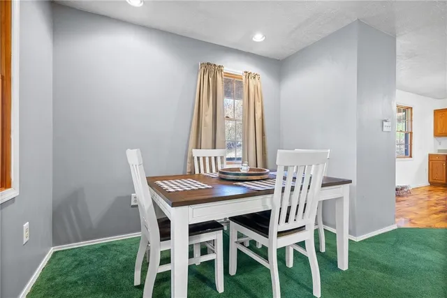 a dining room with a table and chairs