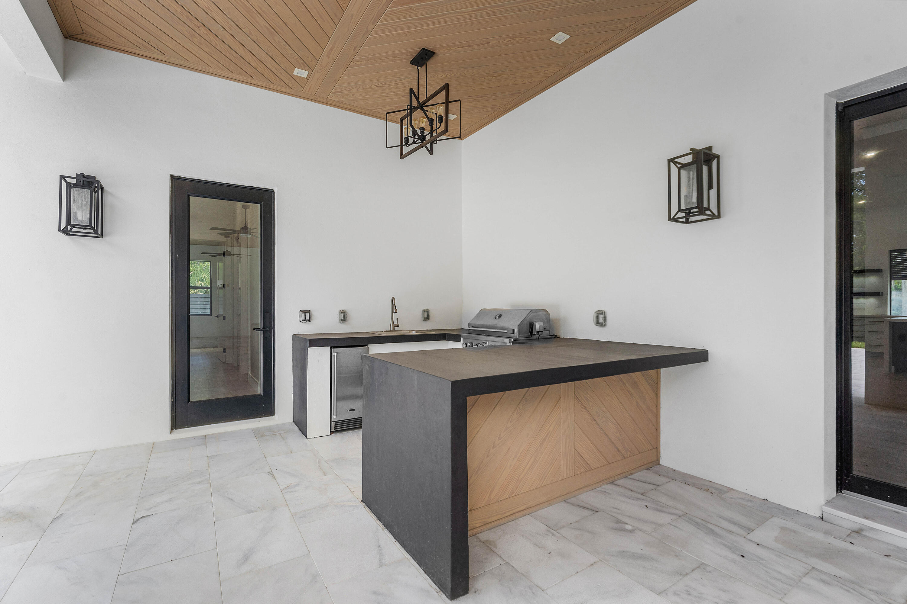 5701 Old Orange Road Jupiter, FL 33458 - Photo 20 of 46 a view of a kitchen with a sink and a refrigerator