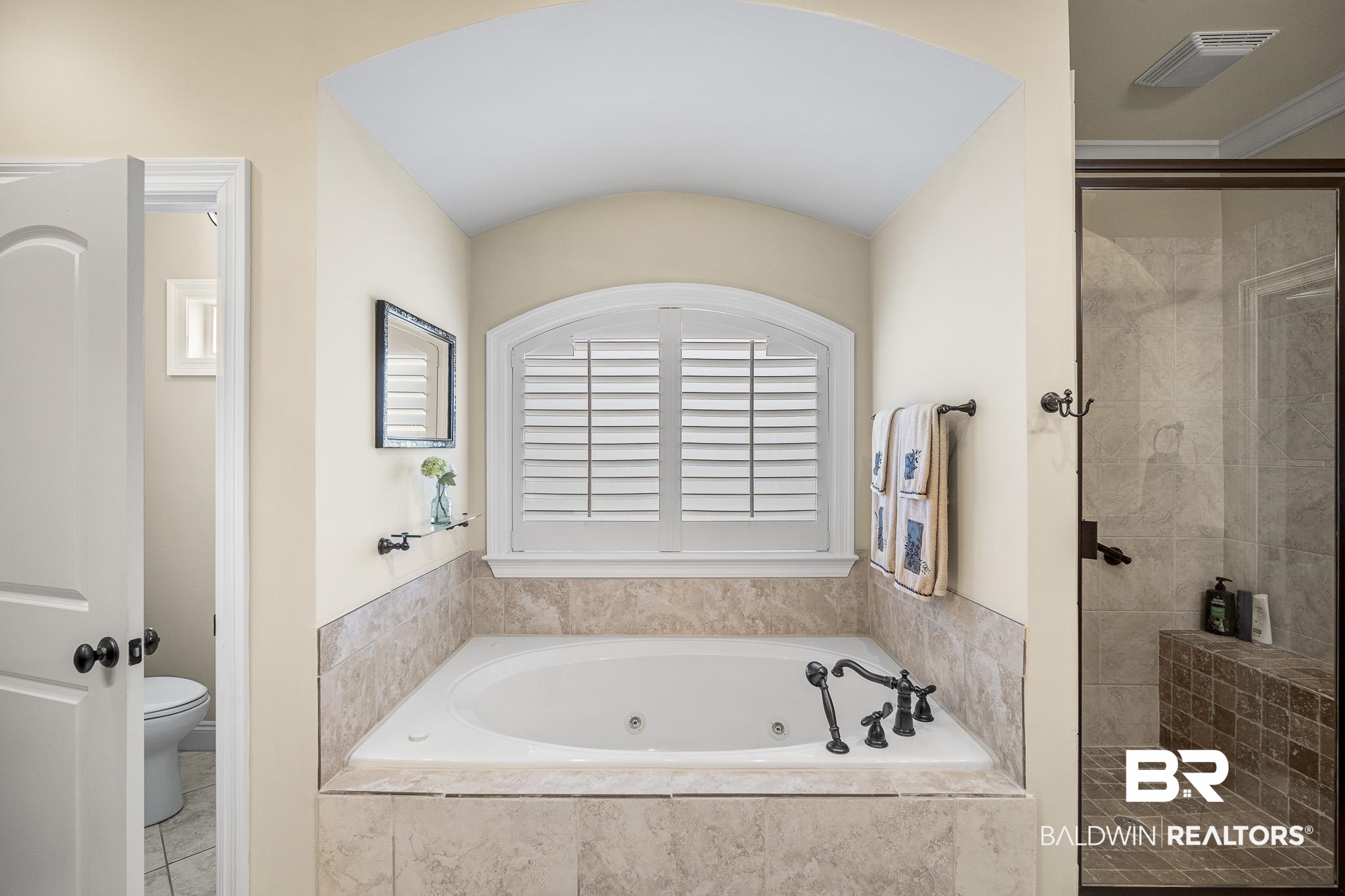 7090 Carson Lane Daphne, AL 36527 - Photo 19 of 37 Bathroom with tile patterned floors, shower with separate bathtub, and toilet