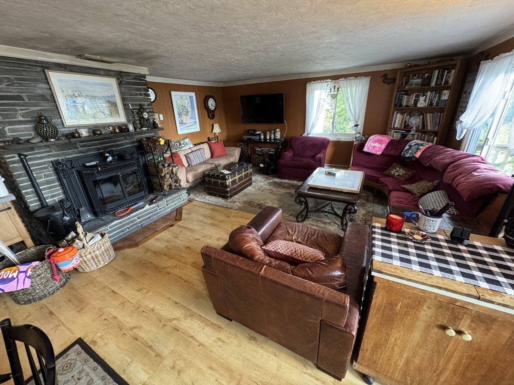 116 Brookfield Road Brimfield, MA 01010 - Photo 11 of 26 a living room with furniture a flat screen tv and a fireplace