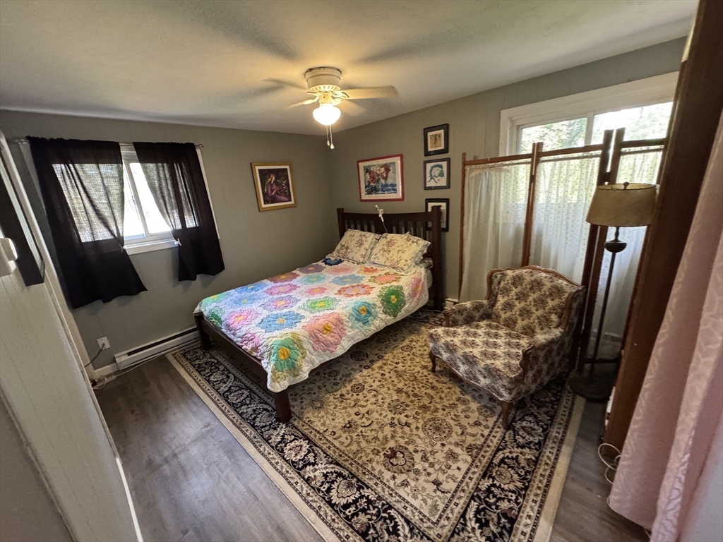 116 Brookfield Road Brimfield, MA 01010 - Photo 22 of 26 a bedroom with a bed wooden floor and a dresser