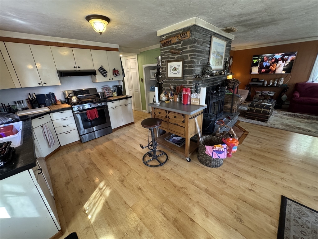 116 Brookfield Road Brimfield, MA 01010 - Photo 9 of 26 a kitchen with granite countertop a stove and cabinets