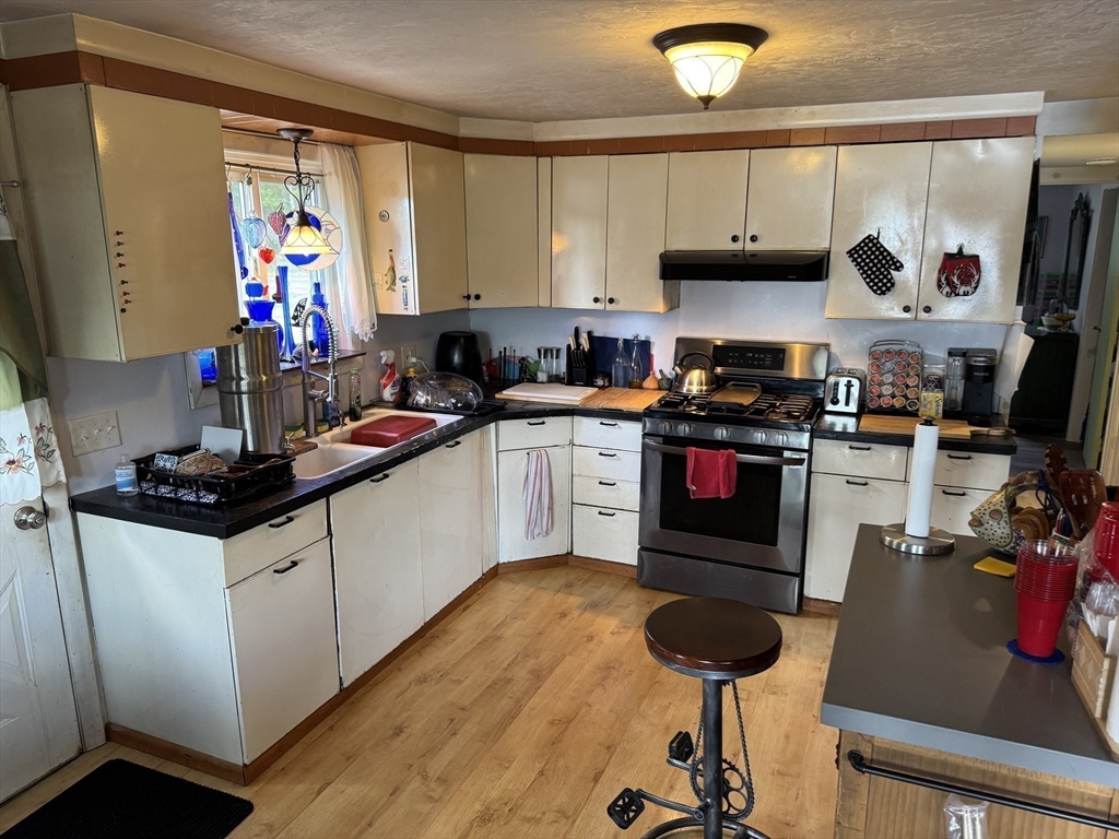 116 Brookfield Road Brimfield, MA 01010 - Photo 10 of 26 a kitchen with stainless steel appliances granite countertop a stove and cabinets