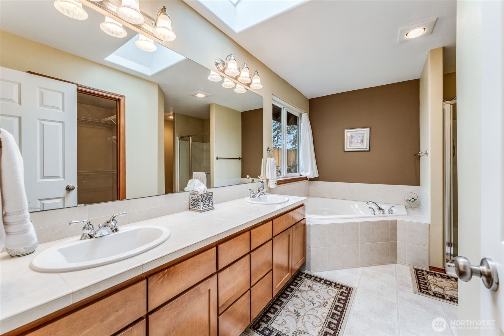 18615 13th Drive Southeast Bothell, WA 98012 - Photo 15 of 38 a bathroom with a tub double sink and a mirror