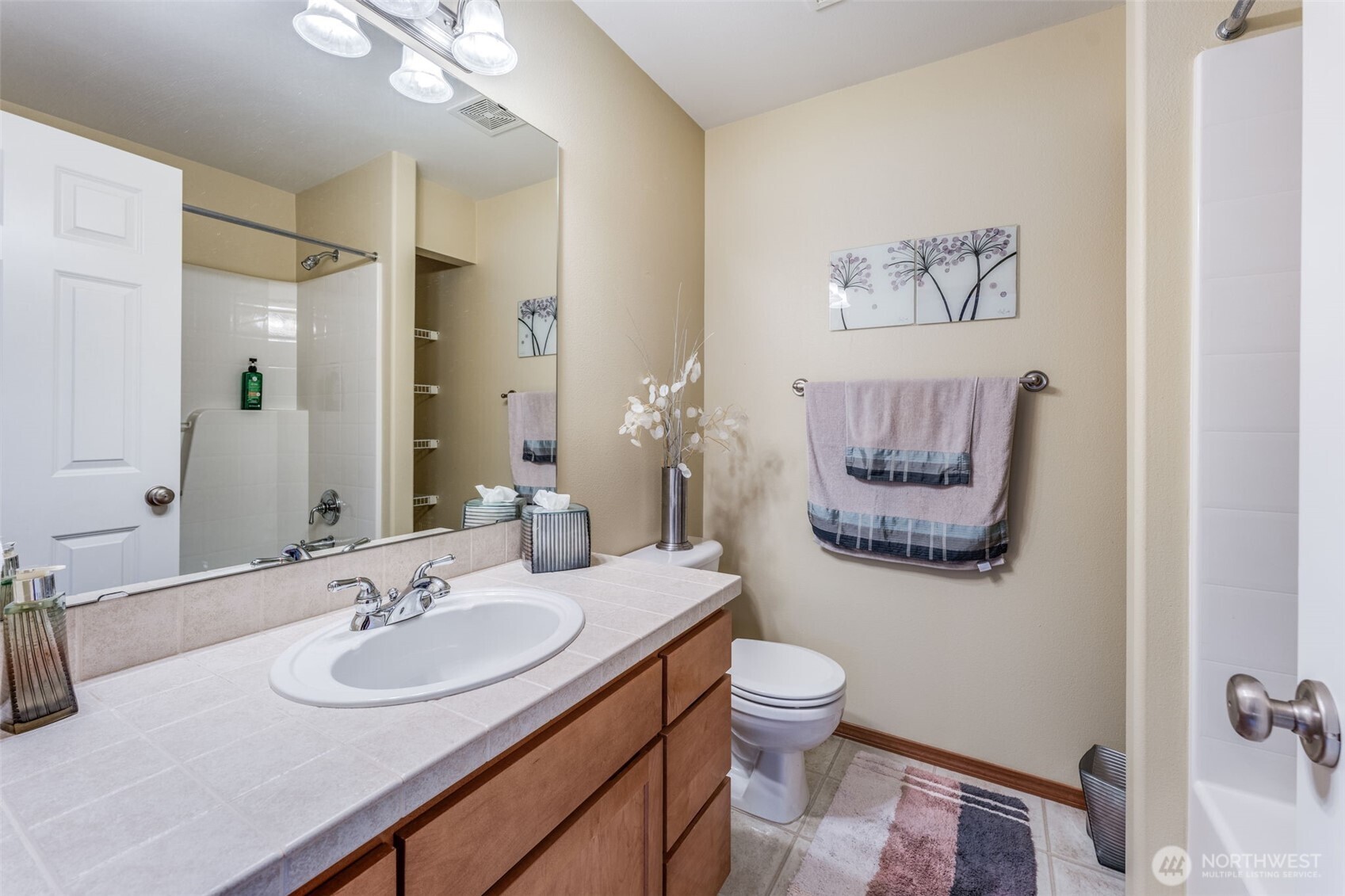 18615 13th Drive Southeast Bothell, WA 98012 - Photo 26 of 38 a bathroom with a toilet a sink and mirror