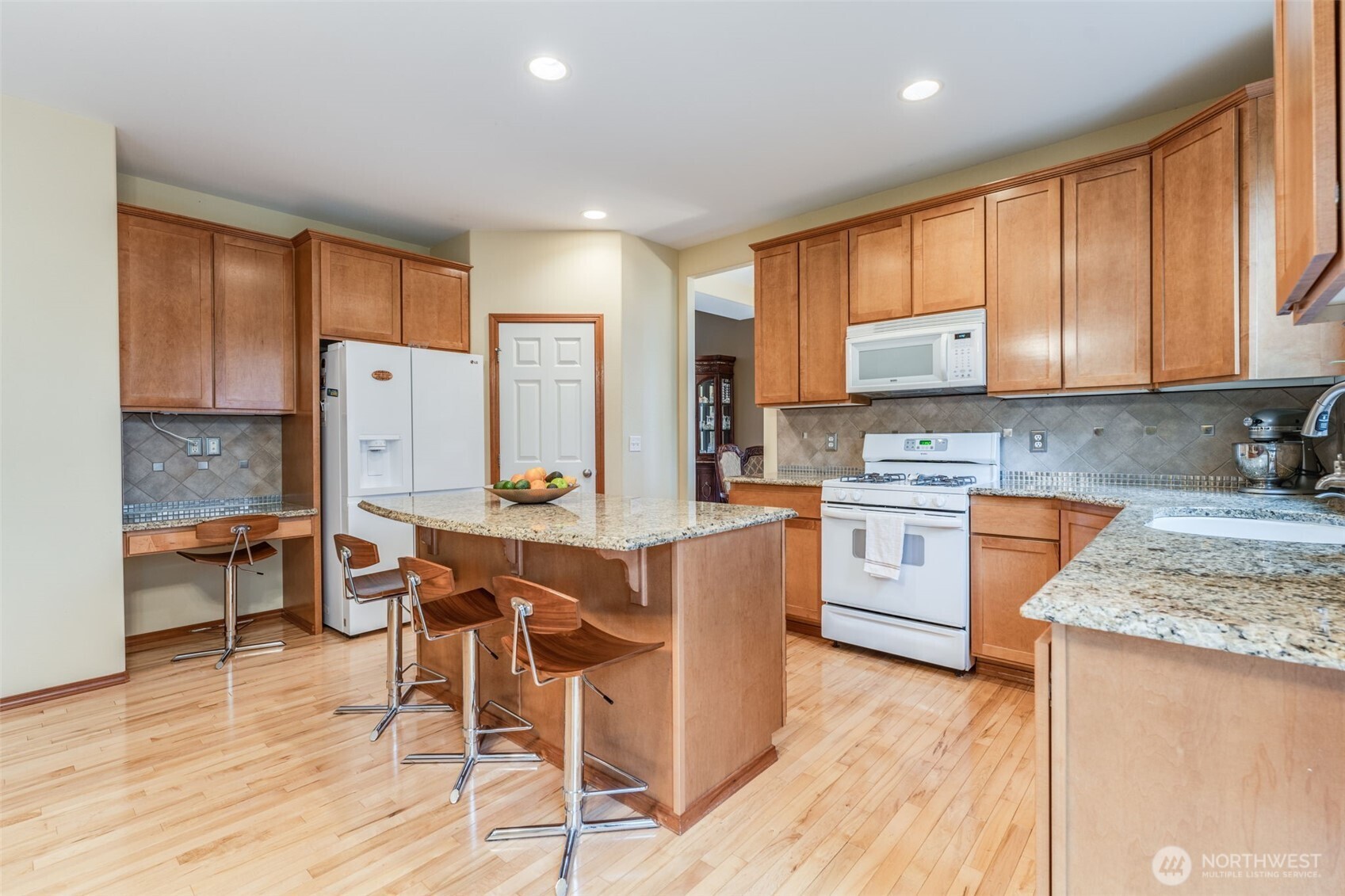 18615 13th Drive Southeast Bothell, WA 98012 - Photo 10 of 38 a kitchen with a table chairs sink refrigerator and cabinets